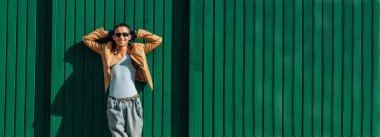 şehir genci yeşil duvara yaslanıyor