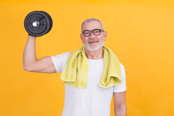 funny mature man with dumbbells isolated