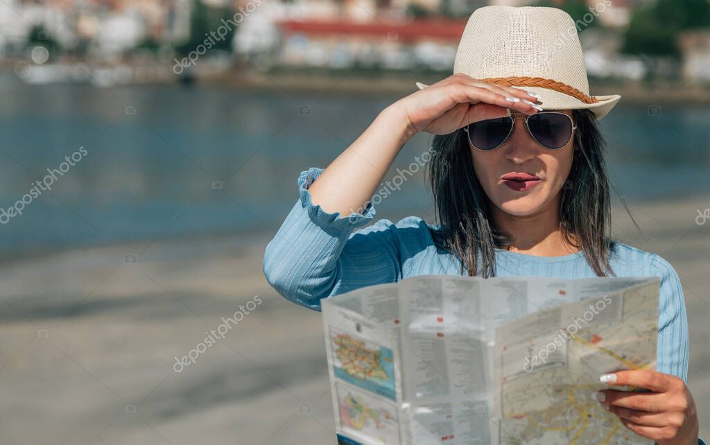 young tourist woman consulting a map