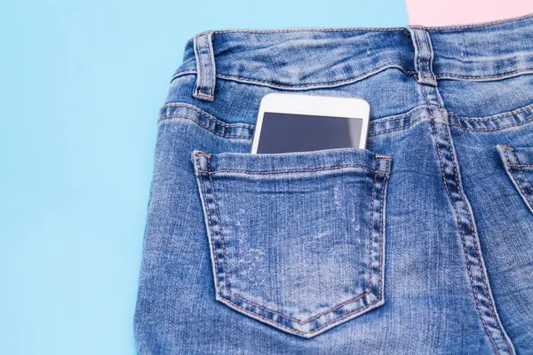 mobile phone in jeans pocket