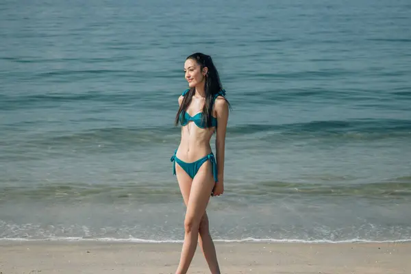 sexy young woman posing in bikini on the beach