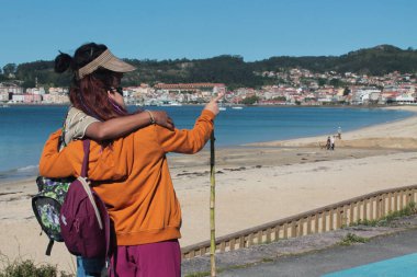 Bir çift gezgin turist manzaranın tadını çıkarıyor ve bir yön gösteriyor.
