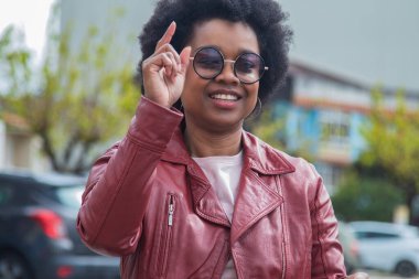 gözlüklü ve deri ceketli şehirli kadın.