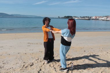 Çiftler kumsalda rahatça eğleniyor.