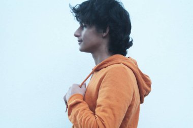 Duvarda svetşörtü olan şehirli genç adam.