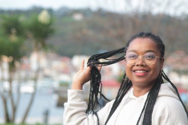 Sokakta rastalı genç siyah kadın.