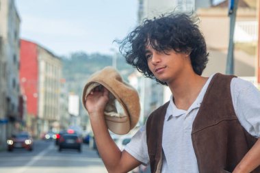 Sokakta şapkalı genç Latin bir adam.