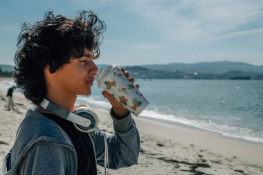 Kulaklıklı genç adam denize bakarken rahatladı.