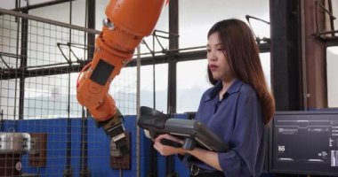 Makine fabrikasında çalışan Asyalı genç bayan işçi.