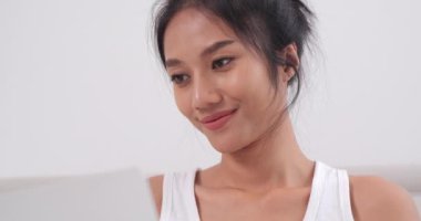 Evdeki bilgisayarını kullanan güzel bir genç kadın.