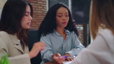 bir grup iş adamı ofiste çalışmayı tartışıyor.