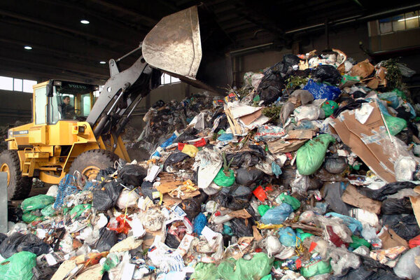 Turin, Piedmont/Italy-03/24/2005-Bulldozer move pile of waste in a landfill.