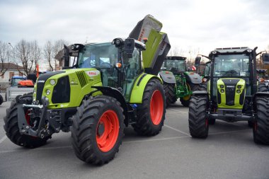 Castelnuovo don Bosco, Piedmont, Italy -11-27-2023- Exhibition of modern tractors and machinery for agriculture clipart