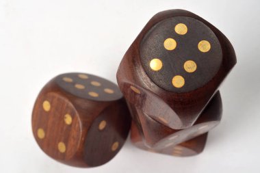 A group of four large wooden gaming dice on a white background