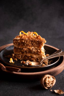 A slice of delicious homeade winter cake with walnus and cinnamon