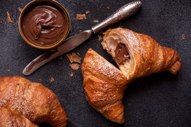 Baked sweet croissants with chocolate, close up 