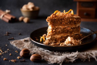 A slice of delicious homeade winter cake with walnus and cinnamon