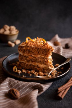A slice of delicious homeade winter cake with walnus and cinnamon