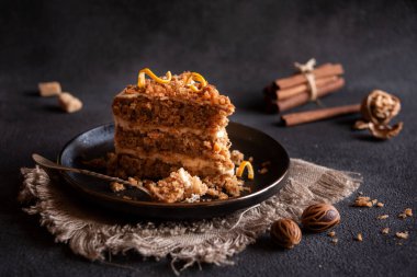A slice of delicious homeade winter cake with walnus and cinnamon