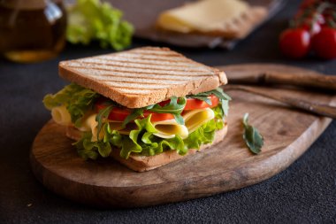 Delicious sandwich with toasted bread, lettuce, cheese and tomatoes.