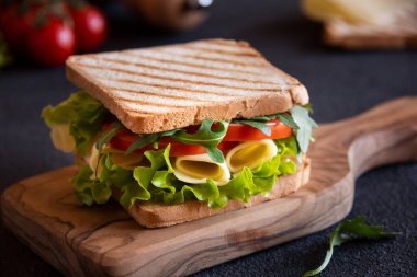 Delicious sandwich with toasted bread, lettuce, cheese and tomatoes.