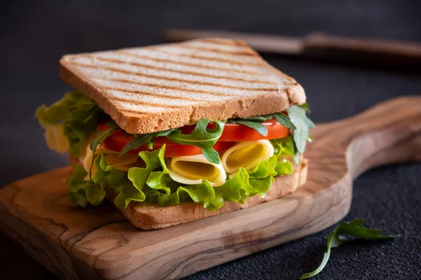 Delicious sandwich with toasted bread, lettuce, cheese and tomatoes.