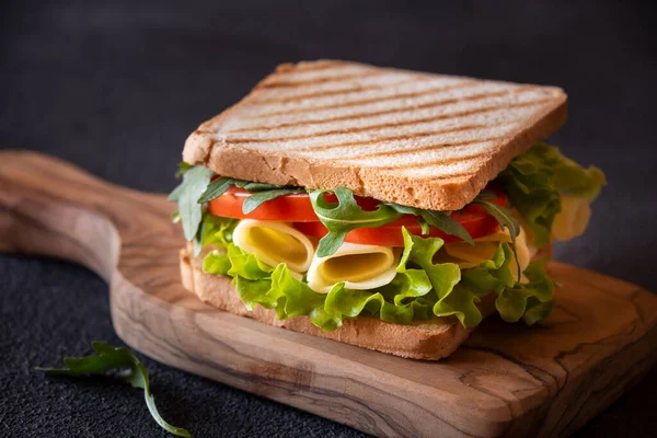 Delicious sandwich with toasted bread, lettuce, cheese and tomatoes.