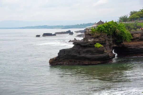 stock image Rocky sea coast with a temple on Bali in Indonesia