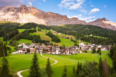Dolomite Alpleri 'nde bir kilisesi olan dağ köyü Yazın yeşil çayırlarda
