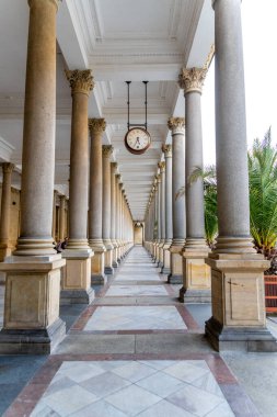 Carlsbad, Karlovy Vary - Çek Cumhuriyeti - 09-23-2022: Süslü sütunları ve Avrupa 'daki bir kaplıca kasabasında merkezi saati olan zamansız bir yürüyüş yolu