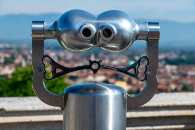 Vicenza, Venetien - Italy - 06-12-2021: Funny looking metallic binoculars at a scenic overlook over Vicenza, Italy from Terrazza di Monte Berico clipart