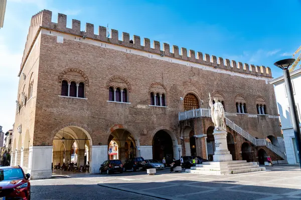 stock image Treviso, Venetien - Italy - 06-08-2021: The iconic Palazzo dei Trecento in Treviso with its arches and windows is located in Piazza dei Signori with its central statue depicting medieval architecture and city life