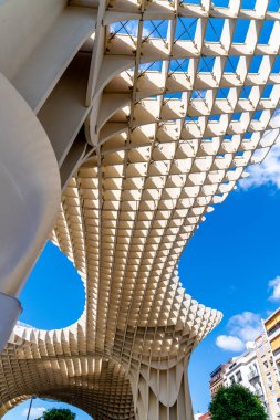Sevilla, Sevilla - İspanya 04-19-2024: Plaza del Cabildo 'dan mağazalar, sütunlar ve bitkilerle dolu bir geçit. Sanatsal olarak boyanmış bir kemer yaklaşık 50 metre uzunluğundaki geçidi süslüyor.