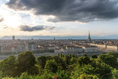 La Linea, Cadiz - İspanya 06-03-2024: Arka planda gökdelenler ve dağlarla sahil yolunda bir adam oturuyor.