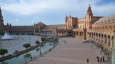 Sevilla, Sevilla - İspanya - 07-02-2024: İspanya 'nın Sevilla kentindeki Plaza de Espana' nın havadan görünüşü, sembolik yarı dairesel bina, kanal, çeşme ve manzaranın tadını çıkaran turistleri gösteriyor.