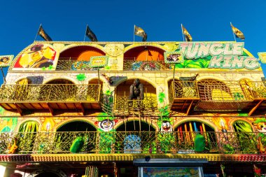 Barcelona, Catalonia - Spain - 01-07-2025: A large multi-story carnival funhouse named Jungle King with a jungle theme, decorative elements, and vibrant artistic walls, creating a festive atmosphere. clipart