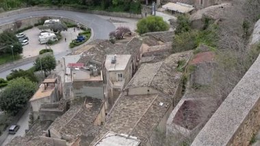 Ragusa, Sizilien - İtalya - 04-03-2025 Redaktionell: Santa Maria delle Scale 'den panoramik manzara çatılar, park edilmiş arabalar ve Ragusa İbla' daki kavisli yollar, tepeler ve taş duvarlarla çevrili.