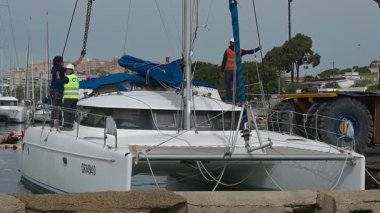 Cagliari - Sardinien - Italien - 03-14-2025: Mürettebat pozisyonları ve vinç güpegündüz liman kenarına yanaşmaya hazırlanıyor.