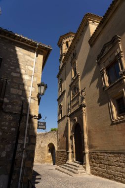BAEZA, SPAIN - SEPTEMBER 07, 2020: Eski Baeza kasabasındaki eski üniversite kulesi, UNESCO, JAen, İspanya 'nın Dünya Mirası Alanına sahip tipik sokaklar.