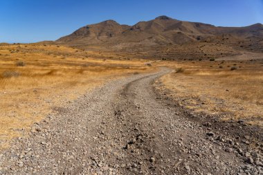 Panoramic view of of mountains with a dirt road in the Gata Cape Natural Park coast. Almera, Andalucia, Spain.