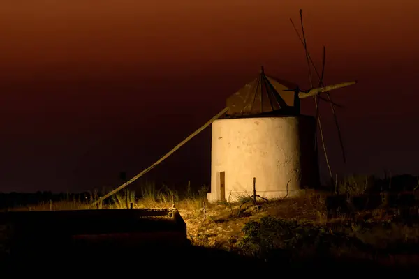 stock image Windmill illuminated at night with the last lights of sunset in the white beautiful village of Vejer de la Frontera, Cadiz province, Andalusia, Spain