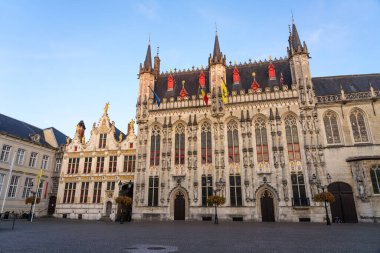 BRUGGE, BELGIUM - 06 Temmuz 2023: De Burg Meydanı ve Belçika 'nın güzel şehri Brugge' un belediye binası alacakaranlıkta, tarihi cepheleriyle.