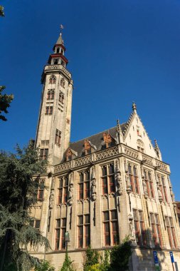 BRUGGE, BELGIUM - 07 Temmuz 2023: Belçika 'nın güzel Brugge kentindeki Spiegelrei kanalı, renkli tarihi cepheleri kanala ve arka planda Jan van Eyckplein meydanına yansıdı.