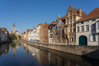 BRUGGE, BELGIUM - 07 Temmuz 2023: Belçika 'nın güzel Brugge kentindeki Spiegelrei kanalı, renkli tarihi cepheleri kanala ve arka planda Jan van Eyckplein meydanına yansıdı.