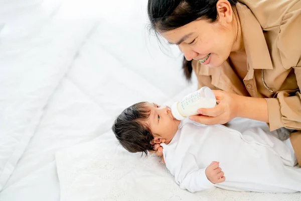 Young Asian Mother Give Milk Bottle Newborn Baby Lie Bed — Stock Photo, Image