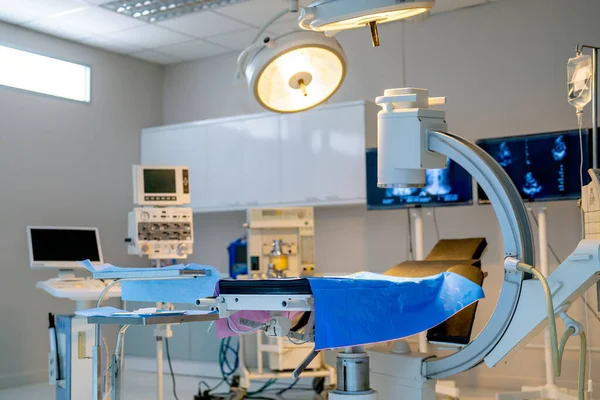 stock image Close up empty operation room with no people and view through clear mirror contain light and tools and instrument to support for treatment the patient.