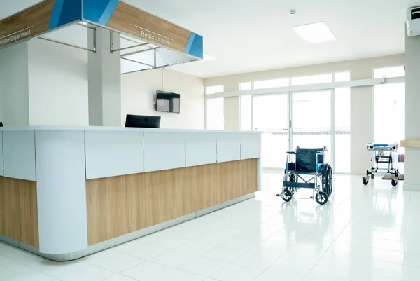 Empty room in area of reception or registration counter in hospital with wheelchair or mobilebed to support healthcare and treatment for patient.