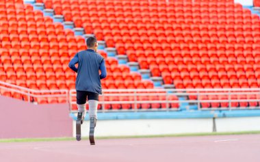 Sporcu atlet protezinin geniş açılı görüntüsü koşuyor ya da gün ışığında stadyumda koşuyor..