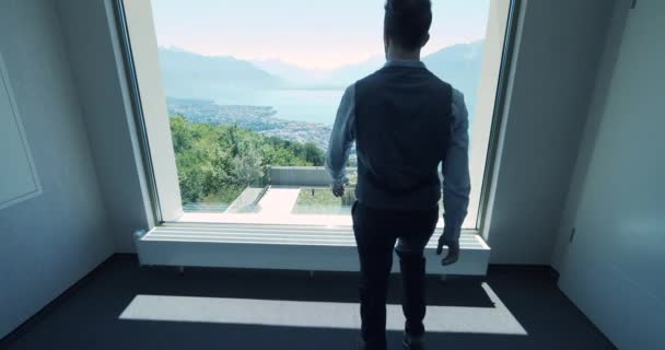 Young Businessman Modern Office Looking Window Breathtaking View Lake Mountains — Stock Video