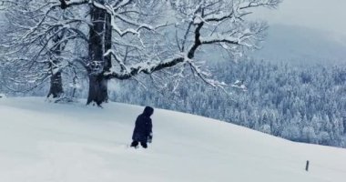 Lost hiker walking outdoors in snow storm